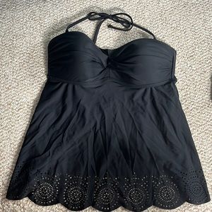 NWT. Black tankini top with cutout design on bottoms.  Crisscross design on top